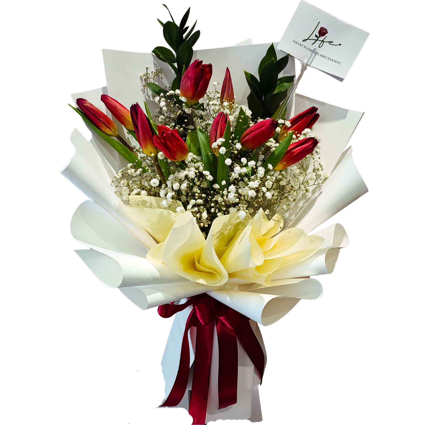 Velvet Kiss bouquet - 10 red tulip buds with yellow bases, white gypsophila and 2 ruscus stems, elegantly wrapped in white floral paper and tied with a bold red ribbon.