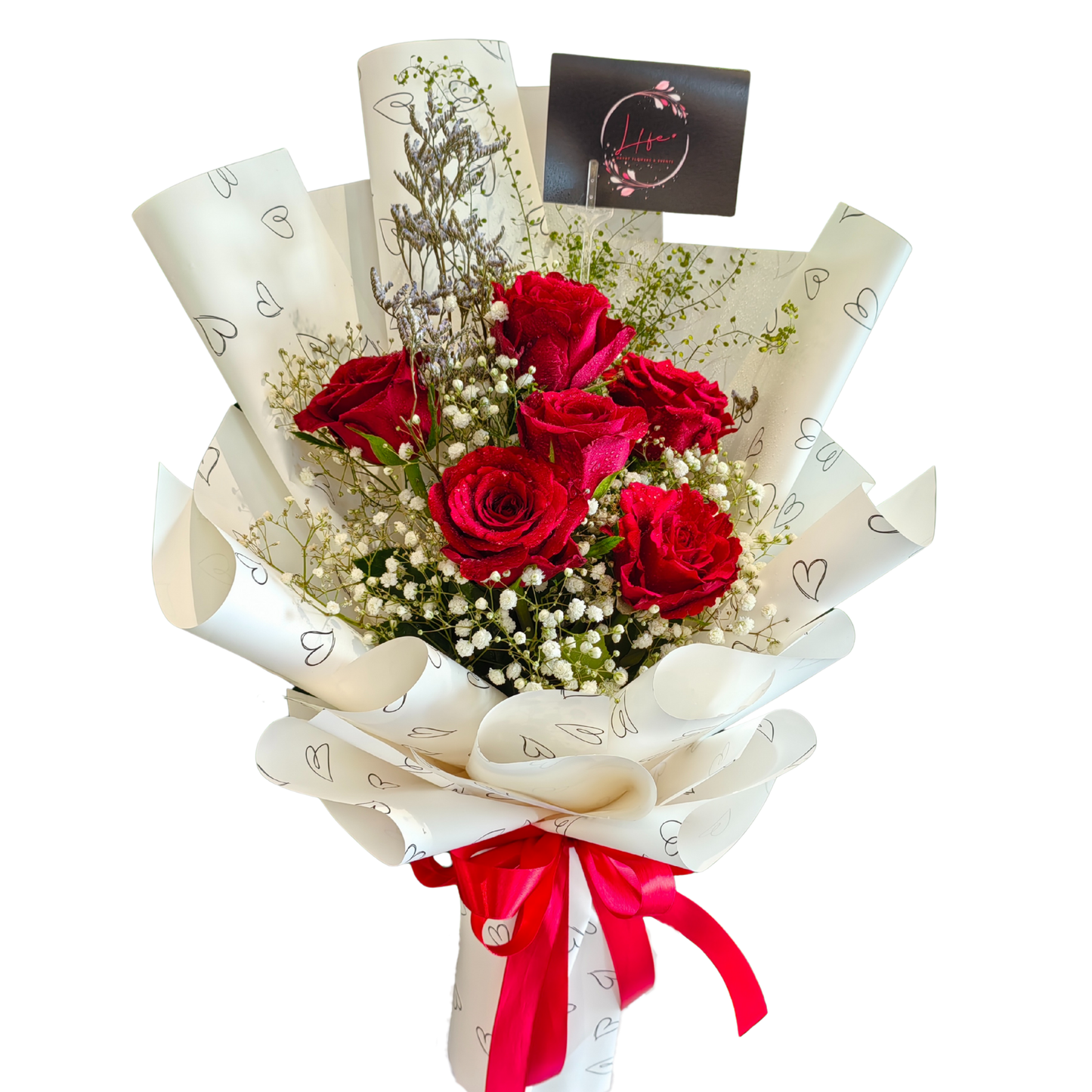 Hayat Flowers' Love Struck bouquet of 6 red roses and white gypsophila, limoniums, and lipidiums. Elegantly wrapped in white floral paper with heart prints and thoughtfully hand-tied with red satin ribbon finish.