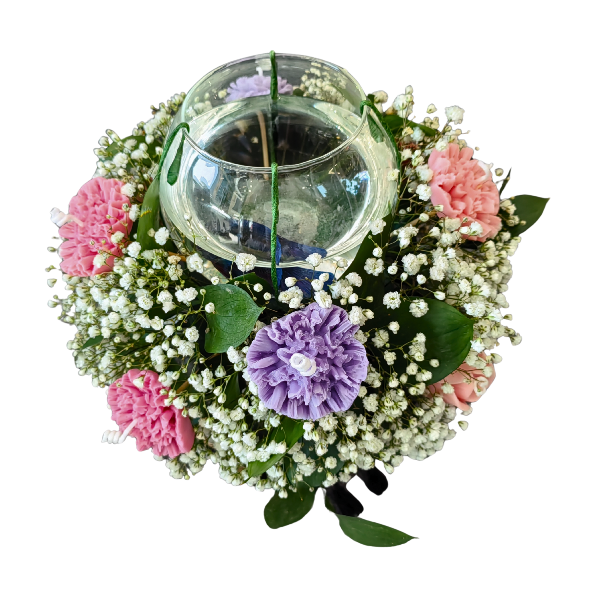 Decorative wreath with carnation flower candles and a glass candle holder set in the middle.
