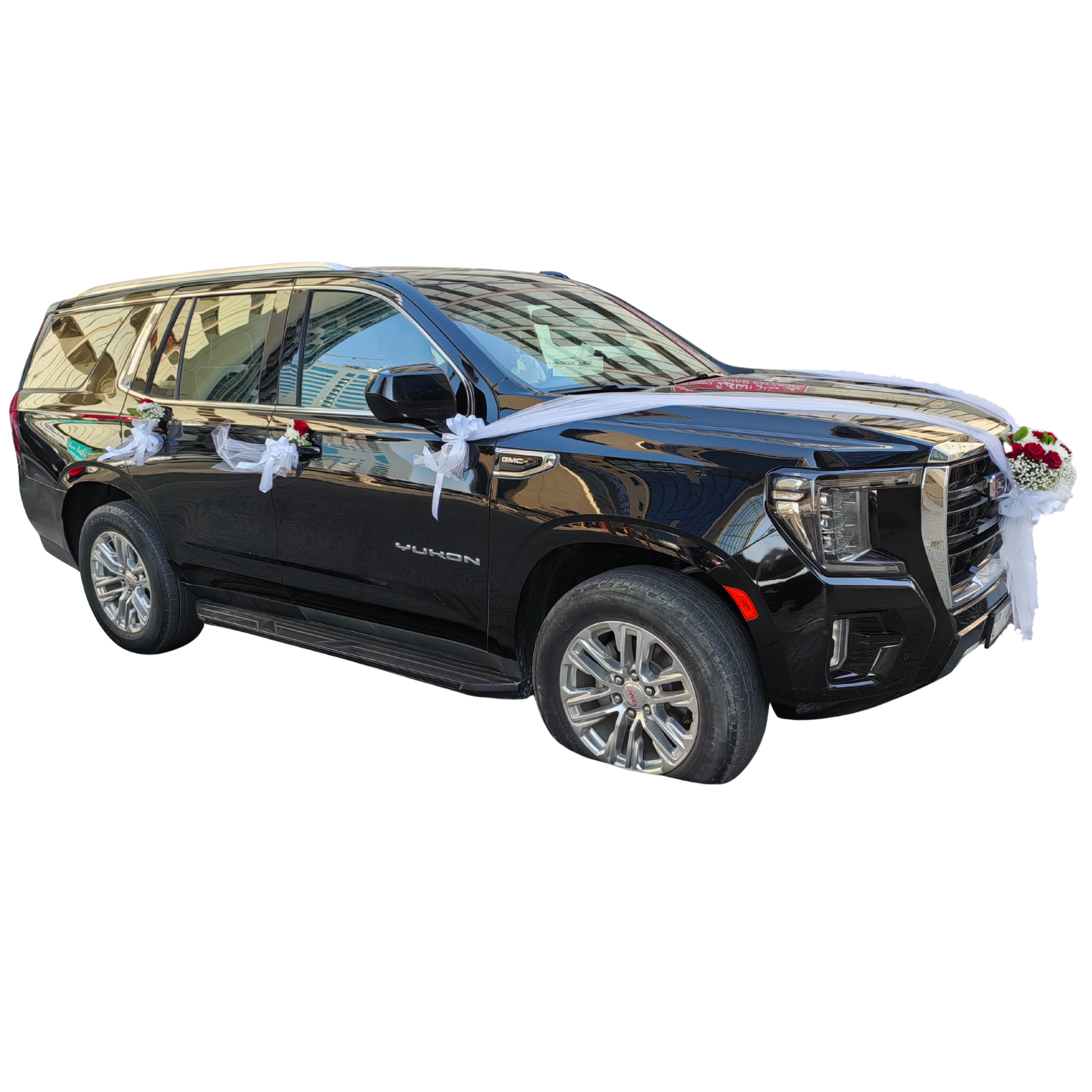 Black wedding car with white decorative embellishments and floral arrangement by Hayat Flowers and Events.
